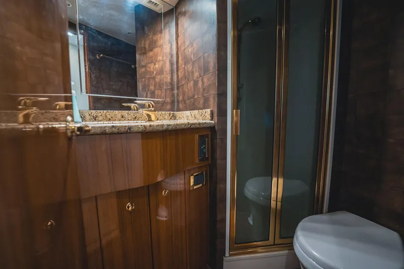 Slide: The Image of Luxurious bathroom in 2005 Viking 48 Convertible yacht with wood cabinetry and glass shower. - 27