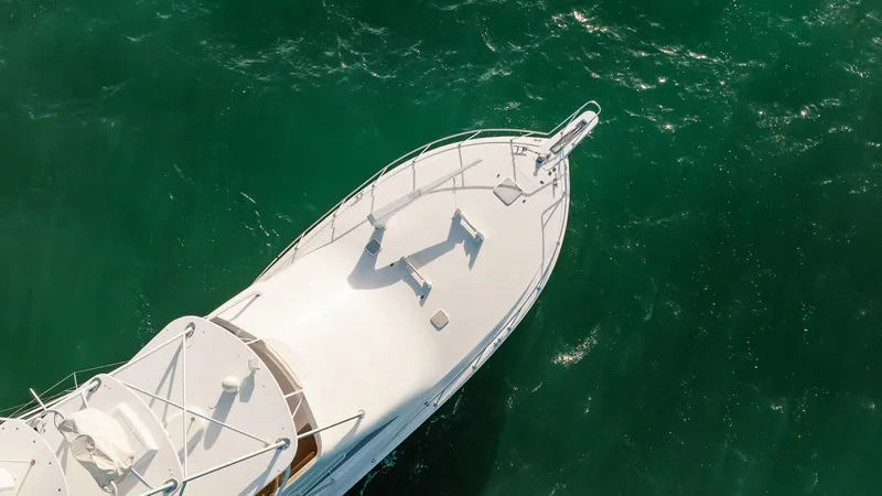 Slide: The Image of Aerial view of 2005 Viking 48 Convertible yacht on vibrant green water. - 37