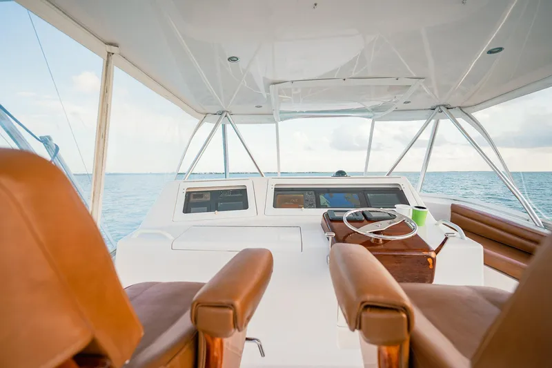 Slide: The Image of 2005 Viking 48 Convertible yacht helm with ocean view and leather seats. - 49