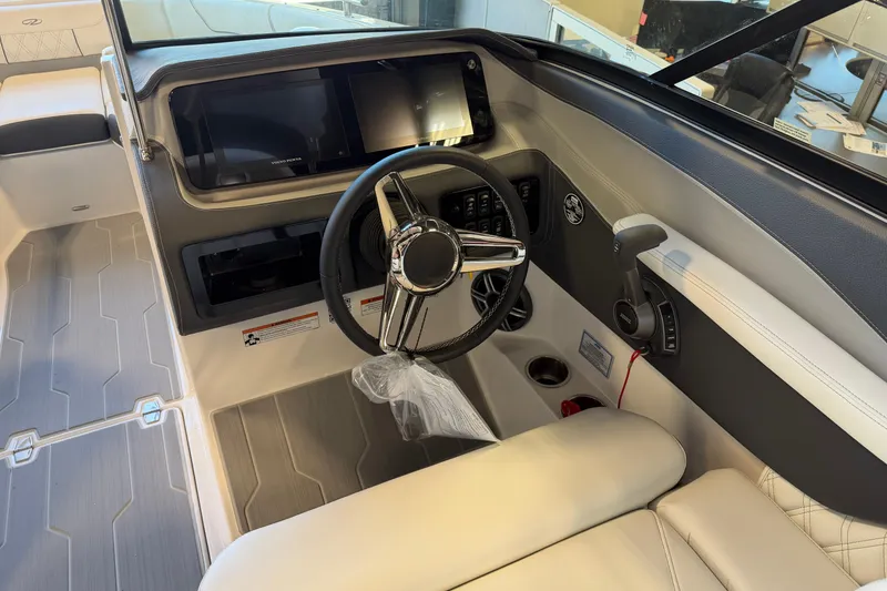 Slide: The Image of 2026 Regal LS6 Surf boat cockpit with modern steering and control panel. - 16