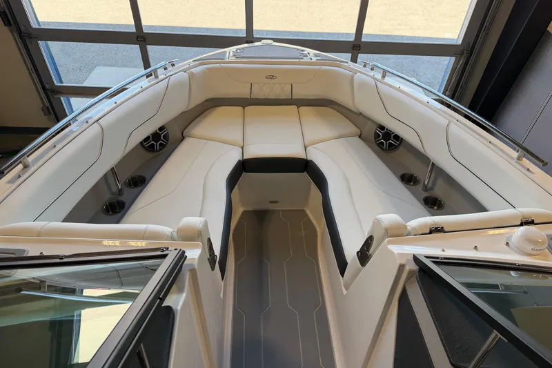 Slide: The Image of 2026 Regal LS6 Surf boat interior with luxurious white seating and cup holders. - 18