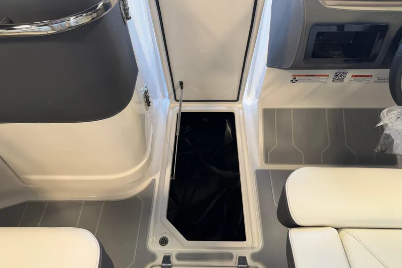 Slide: The Image of 2026 Regal LS6 Surf boat interior with open storage compartment and seating. - 24