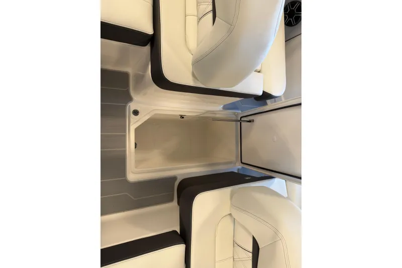 Slide: The Image of 2026 Regal LS6 Surf boat interior with sleek seating and storage compartment. - 25
