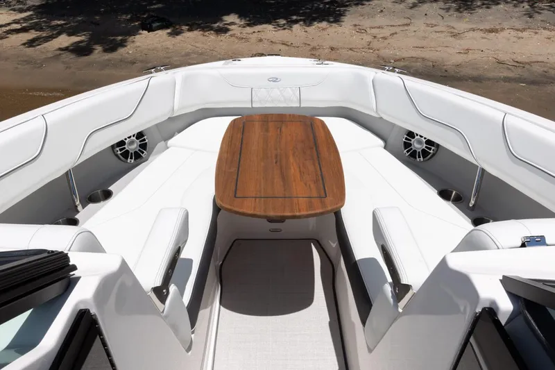 Slide: The Image of Manufacturer Provided Image: 2026 Regal LS6 Surf boat interior with elegant seating and wooden table. - 3