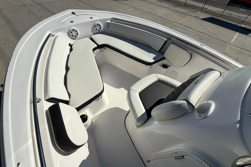 Slide: The Image of 2023 Tidewater 198 CC Adventure boat interior with cushioned seating and speakers. - 10