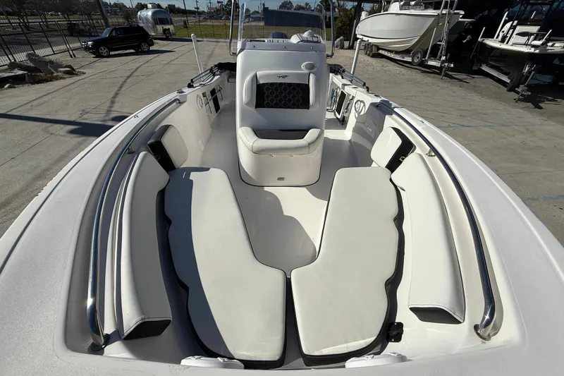 Slide: The Image of 2023 Tidewater 198 CC Adventure boat interior with cushioned seating and sleek design. - 11