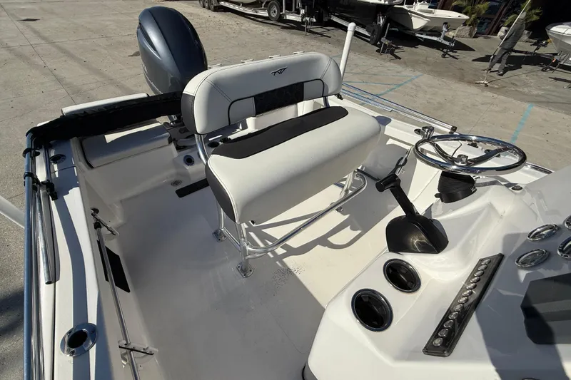 Slide: The Image of 2023 Tidewater 198 CC Adventure boat interior with steering wheel and seating. - 12