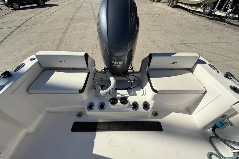 Slide: The Image of 2023 Tidewater 198 CC Adventure boat interior with engine and seating. - 13