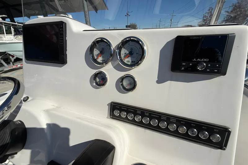 Slide: The Image of 2023 Tidewater 198 CC Adventure boat dashboard with gauges and JL Audio system. - 15