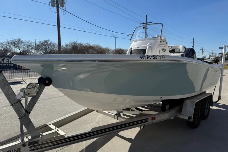 Slide: The Image of 2023 Tidewater 198 CC Adventure boat on trailer, parked outdoors. - 4