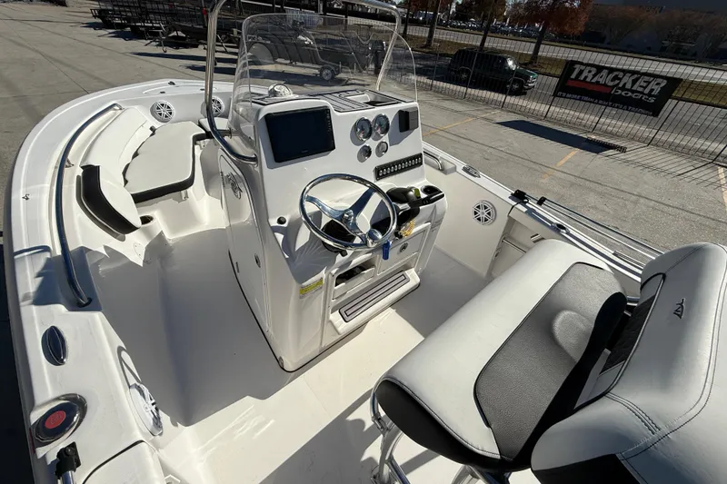 Slide: The Image of 2023 Tidewater 198 CC Adventure boat interior with steering console and seating. - 9