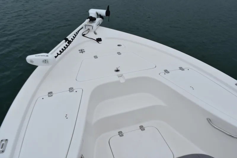 Slide: The Image of 2020 Sea Pro 208 Bay boat deck with storage compartments and trolling motor. - 10