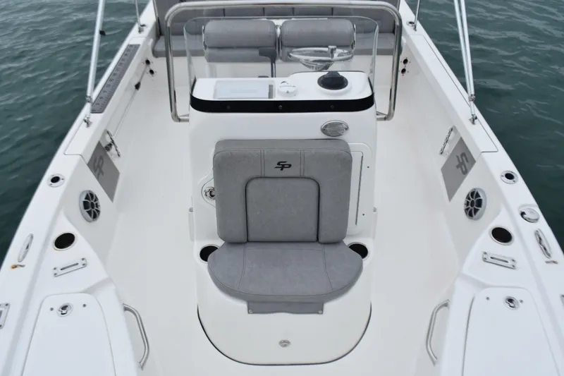 Slide: The Image of 2020 Sea Pro 208 Bay boat interior with seating and console, on calm water. - 16