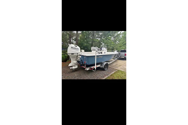 The Image of 2020 Sea Pro 208 Bay boat on calm water with overcast sky. - 2