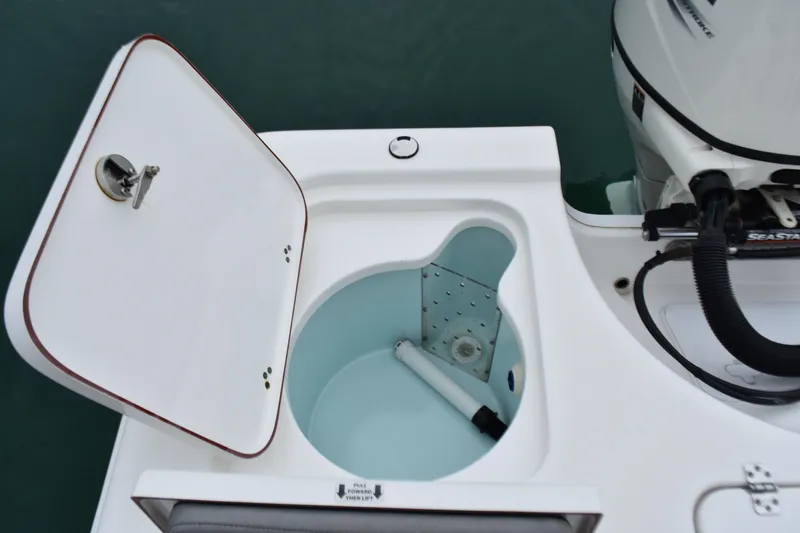 Slide: The Image of 2020 Sea Pro 208 Bay boat with open storage compartment and motor detail. - 25