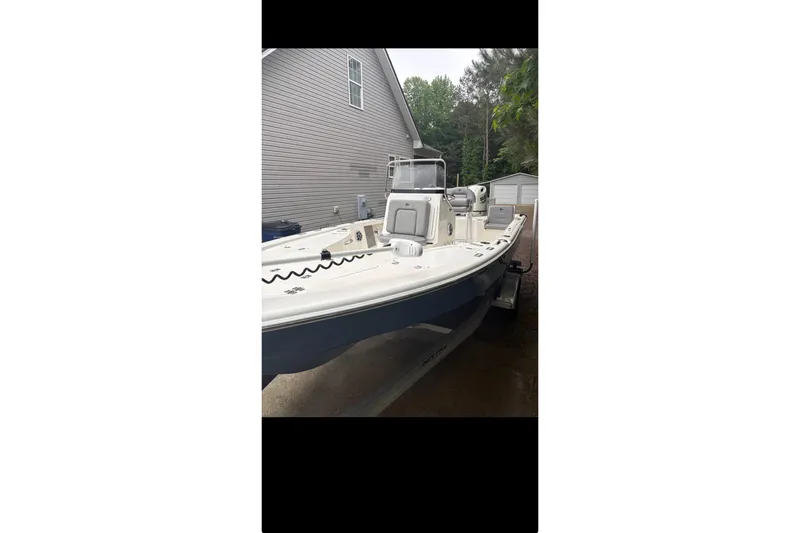 Slide: The Image of 2020 Sea Pro 208 Bay boat on calm water with a person standing at the helm. - 3