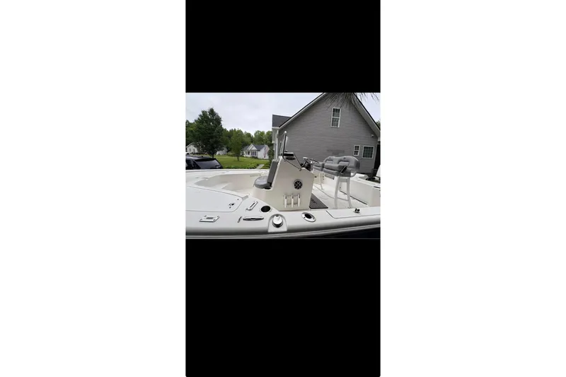 Slide: The Image of 2020 Sea Pro 208 Bay boat on calm water with overcast sky. - 5