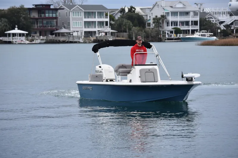 Slide: The Image of 2020 Sea Pro 208 Bay boat cruising on calm water near waterfront homes. - 8