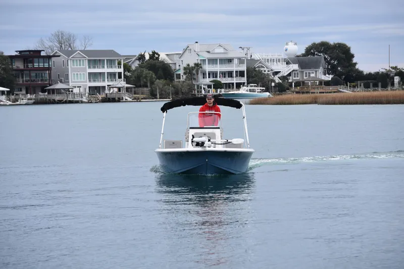 Slide: The Image of 2020 Sea Pro 208 Bay boat cruising on calm water near waterfront homes. - 9