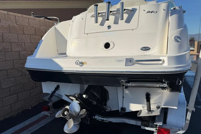 Slide: The Image of 2008 Sea Ray 240 Sundancer boat rear view with propeller and trailer. - 2