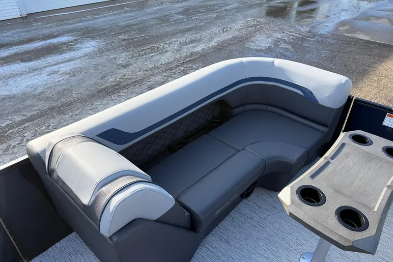 Slide: The Image of 2026 Bennington 22 S Sport Quad Bench with sleek gray seating and cup holders. - 11