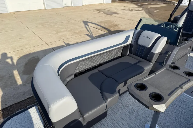 Slide: The Image of 2026 Bennington 22 S Sport Quad Bench with luxurious seating and cup holders. - 12
