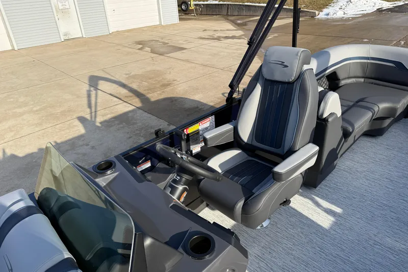 Slide: The Image of 2026 Bennington 22 S Sport Quad Bench boat interior with sleek seating and steering console. - 15