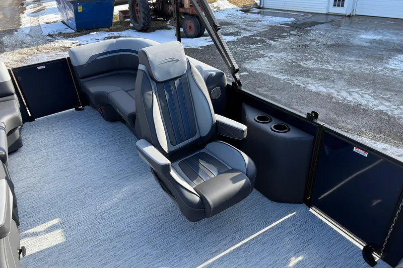 Slide: The Image of 2026 Bennington 22 S Sport Quad Bench interior with luxurious seating and cup holders. - 16