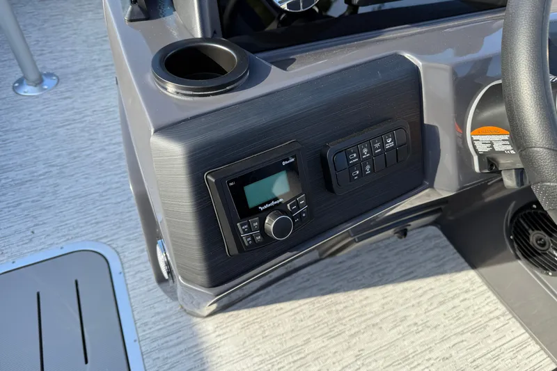 Slide: The Image of Control panel of 2026 Bennington 22 S Sport Quad Bench boat with audio system and cup holder. - 19