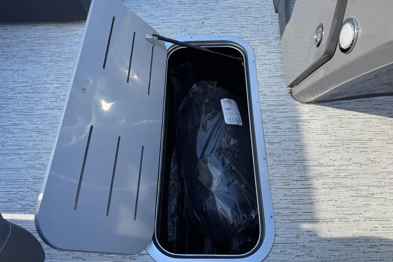 Slide: The Image of Open storage compartment on 2026 Bennington 22 S Sport Quad Bench boat. - 20