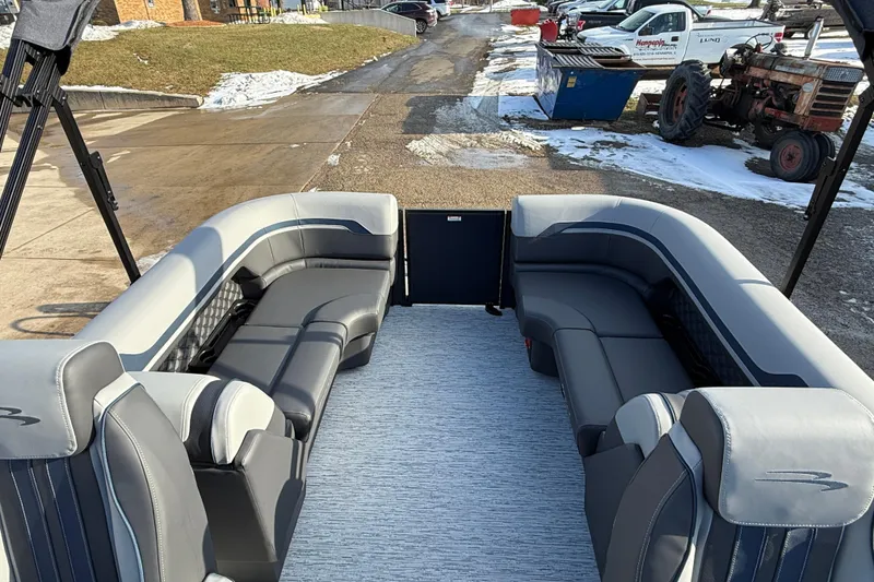 Slide: The Image of 2026 Bennington 22 S Sport Quad Bench interior with gray seating and open layout. - 24