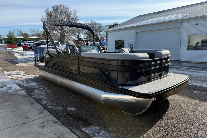 Slide: The Image of 2026 Bennington 22 S Sport Quad Bench pontoon boat parked outdoors. - 3