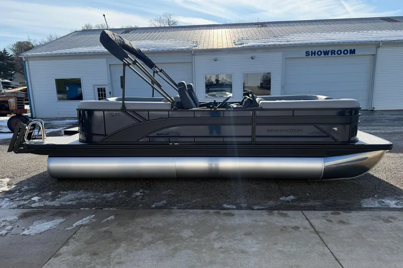 Slide: The Image of 2026 Bennington 22 S Sport Quad Bench pontoon boat outside showroom. - 4