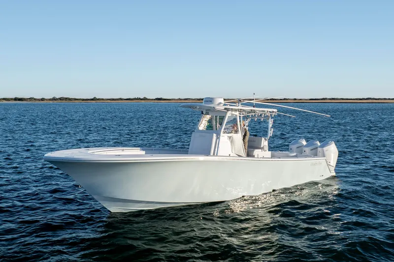 The Image of 2024 Onslow Bay 33 TE boat cruising on open water under clear blue sky. - 0