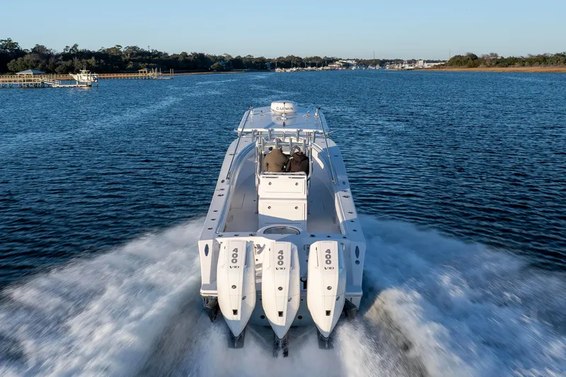 Slide: The Image of 2024 Onslow Bay 33 TE boat cruising on a scenic waterway. - 12