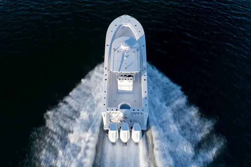 Slide: The Image of 2024 Onslow Bay 33 TE boat cruising on open water, aerial view. - 13