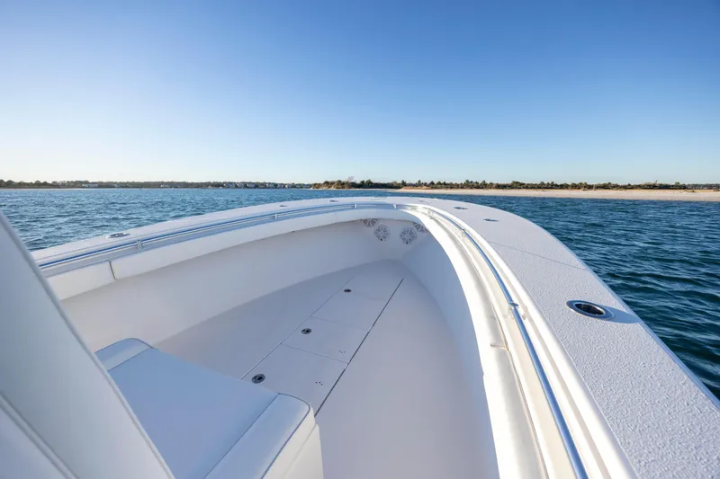 Slide: The Image of 2024 Onslow Bay 33 TE boat on calm water, clear sky, coastal view. - 15