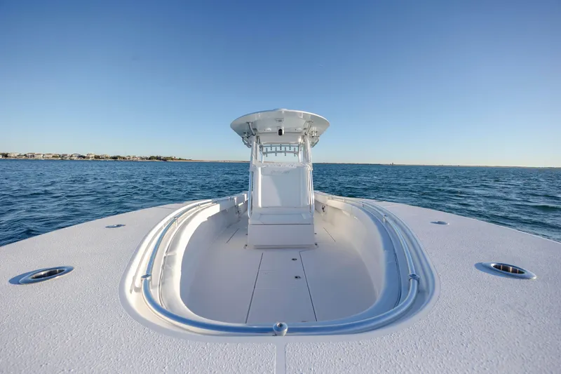 Slide: The Image of 2024 Onslow Bay 33 TE boat on open water, clear sky background. - 18