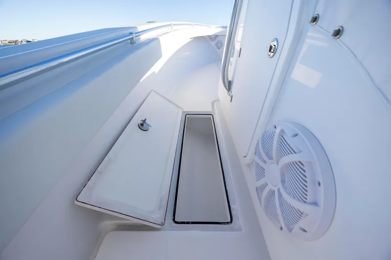 Slide: The Image of 2024 Onslow Bay 33 TE boat interior with storage compartment and speaker. - 21