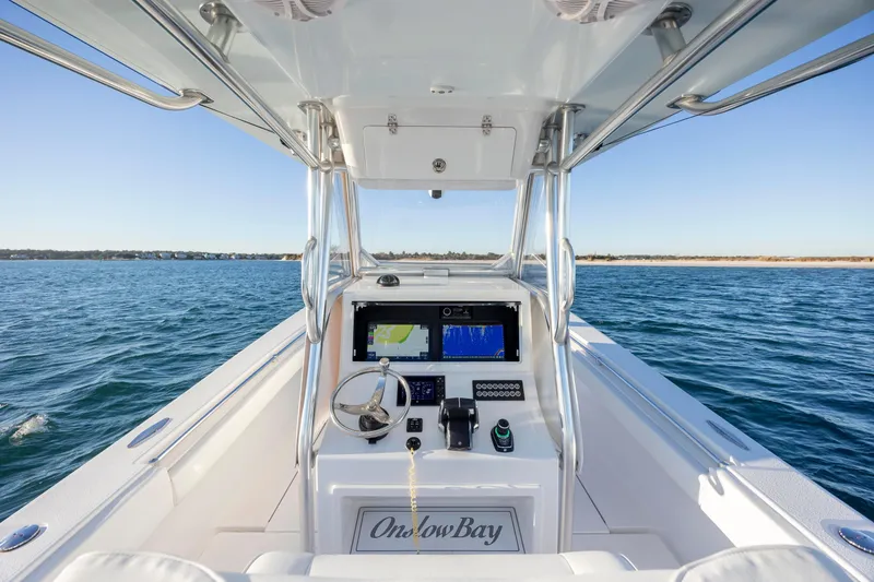 Slide: The Image of 2024 Onslow Bay 33 TE boat dashboard with navigation system on open water. - 23
