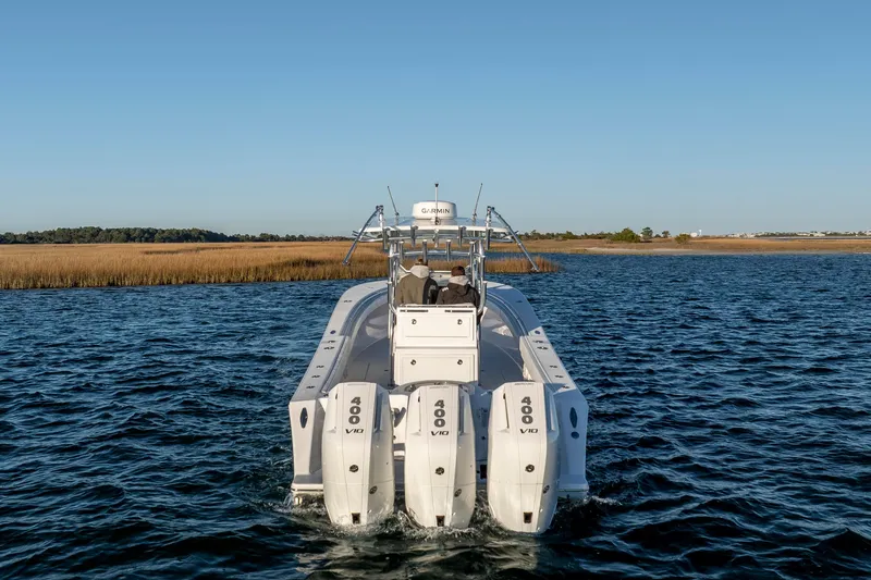 Slide: The Image of 2024 Onslow Bay 33 TE boat with triple 400 V10 engines on open water. - 3