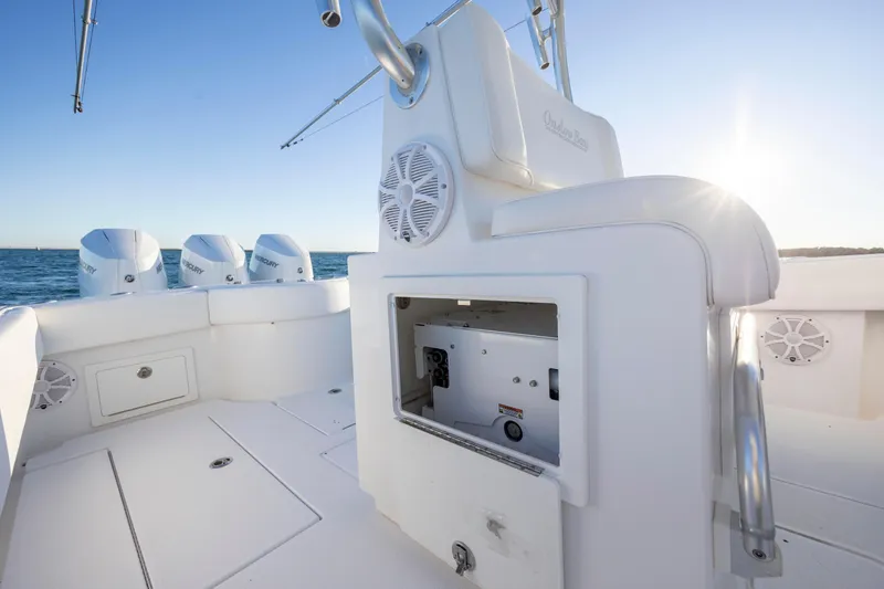 Slide: The Image of 2024 Onslow Bay 33 TE boat interior with open storage, speakers, and triple Mercury engines. - 31