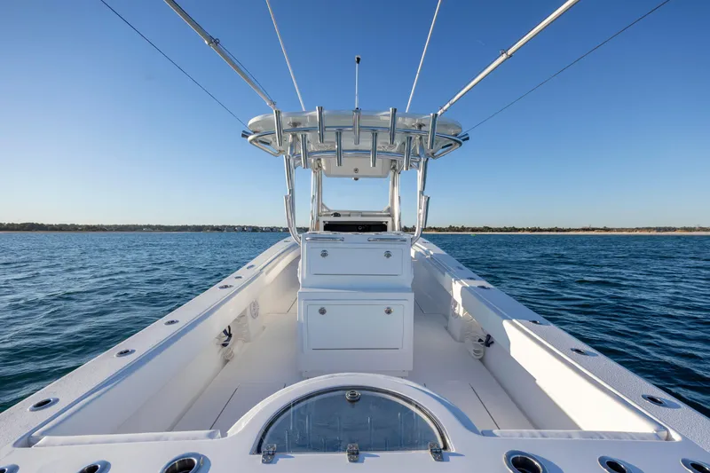 Slide: The Image of 2024 Onslow Bay 33 TE boat on open water, clear sky, spacious deck. - 32
