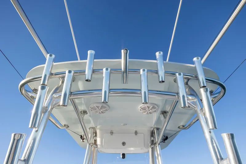 Slide: The Image of 2024 Onslow Bay 33 TE boat's rod holders and T-top against clear blue sky. - 33