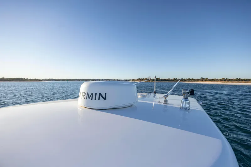 Slide: The Image of 2024 Onslow Bay 33 TE boat with Garmin equipment on calm water. - 34