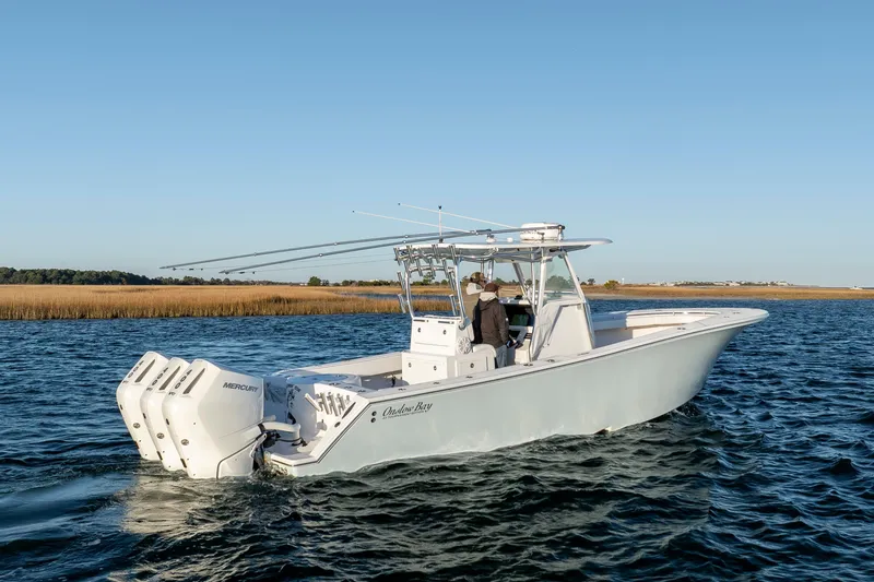 Slide: The Image of 2024 Onslow Bay 33 TE boat with triple Mercury engines on open water. - 4