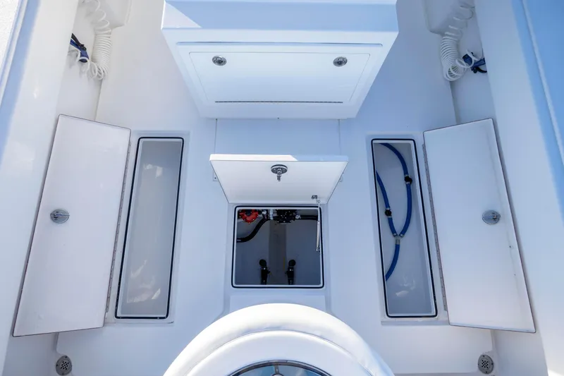 Slide: The Image of 2024 Onslow Bay 33 TE boat interior with storage compartments and plumbing. - 40