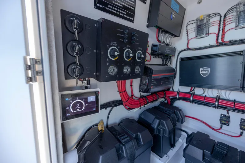 Slide: The Image of Electrical system of 2024 Onslow Bay 33 TE boat with control panels and wiring. - 44