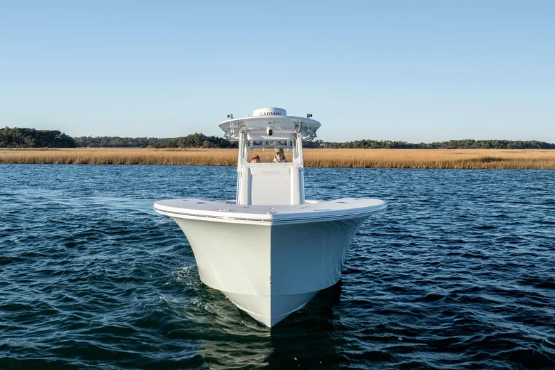 Slide: The Image of 2024 Onslow Bay 33 TE boat cruising on open water under clear blue sky. - 7