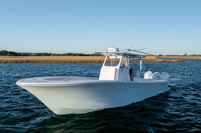 Slide: The Image of 2024 Onslow Bay 33 TE boat cruising on a calm lake under clear skies. - 8